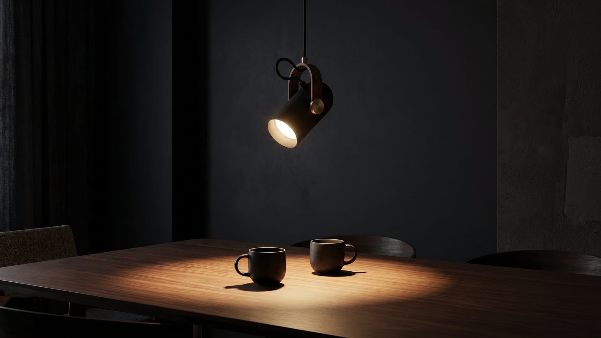 The Tilt pendant lit low over a dark walnut dining table at night
