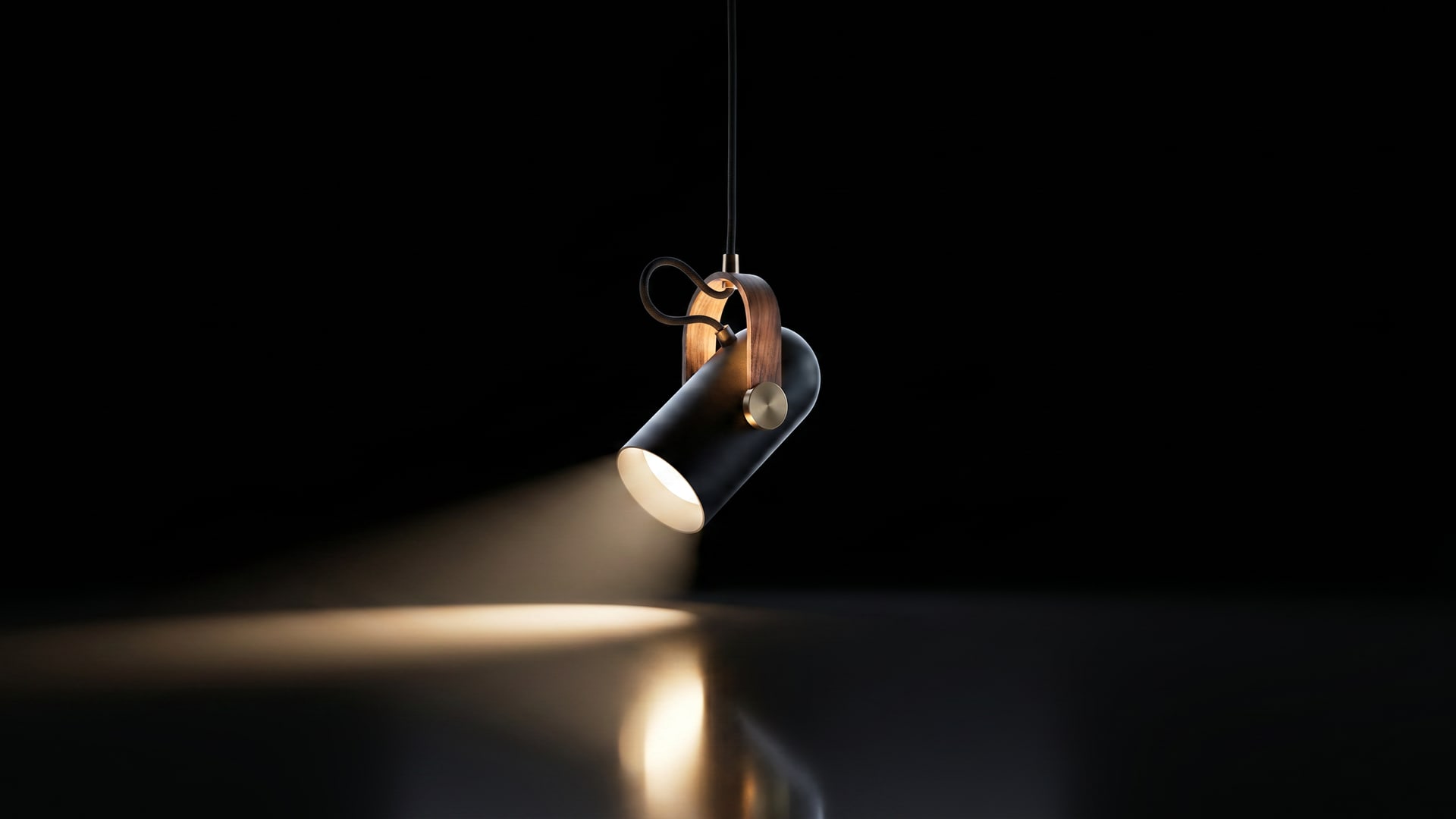 The same frame illuminated — a warm beam pooling on the dark floor